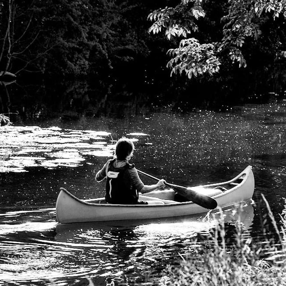 Solo paddling, captured in black and white